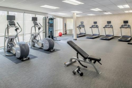 a gym with several treadmills and cardio machines at Courtyard by Marriott Houston City Place in Spring