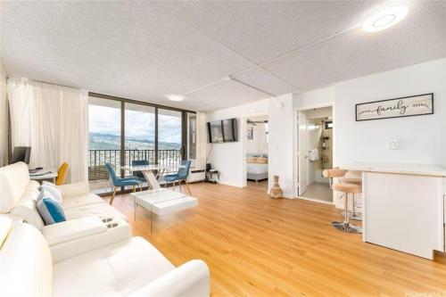 a living room with a white couch and a table at Waikiki Banyan #3013 - Tower 2 in Honolulu