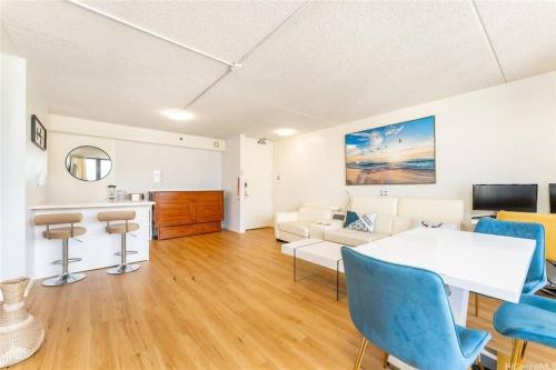 a living room with a couch and a table and chairs at Waikiki Banyan #3013 - Tower 2 in Honolulu