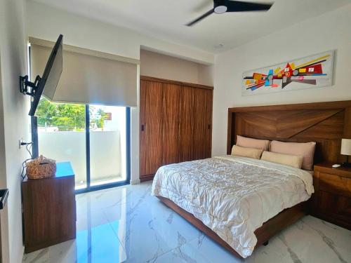 a bedroom with a large bed and a window at Privada Huayacan in Cancún