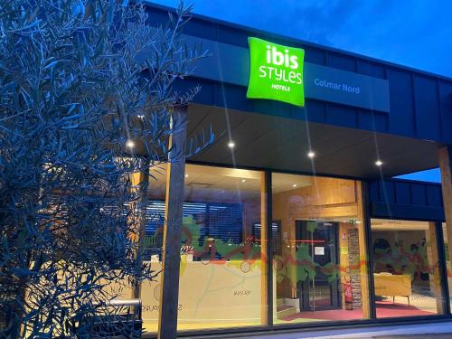a store with a sign on the side of a building at Ibis Styles Colmar Nord in Colmar
