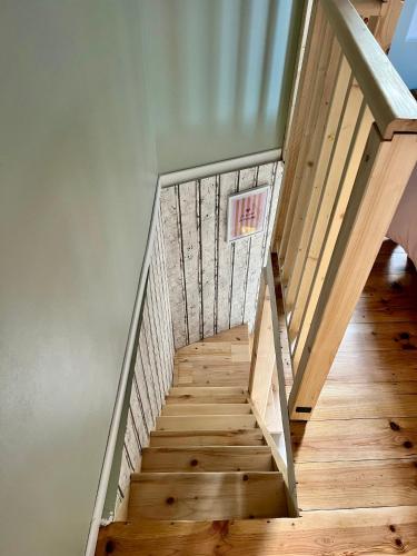 a staircase in a house with wooden floors at Un petit cocon in Commercy