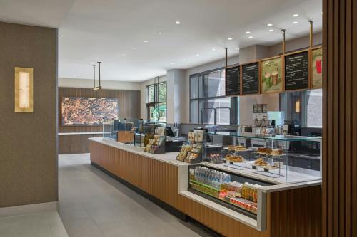 a restaurant with a counter with food on display at Denver Airport Marriott at Gateway Park in Aurora
