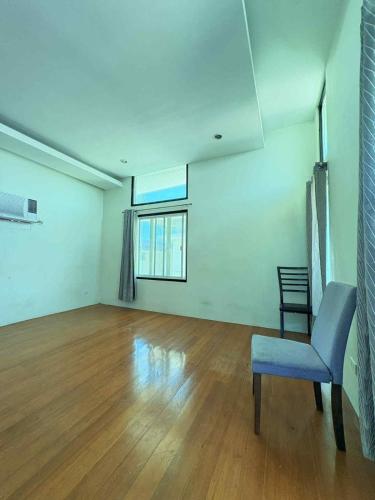 an empty room with a chair and a window at Malibu Lanang SMX convention nearby Full house in Davao City