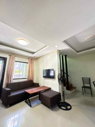 a living room with a couch and a table at Malibu Lanang SMX convention nearby Full house in Davao City
