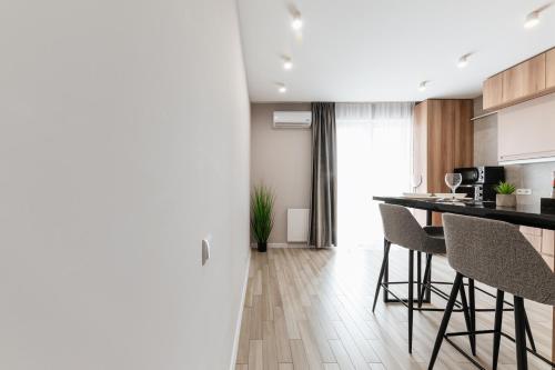 a kitchen with a counter and chairs in a room at Luxury Apartments Babyak in Uzhhorod