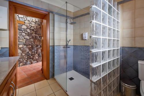 un bagno con doccia con porta in vetro di El Almendro a Tesbabo