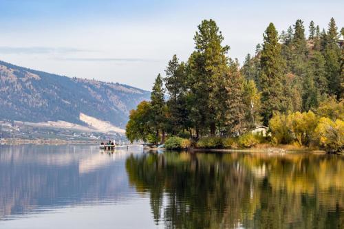 a view of a lake with trees on the shore at Holiday Inn Express & Suites Kelowna - East by IHG in Kelowna