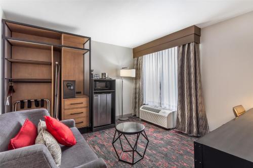 a living room with a couch and a window at Best Western Downtown PLUS Music Row in Nashville