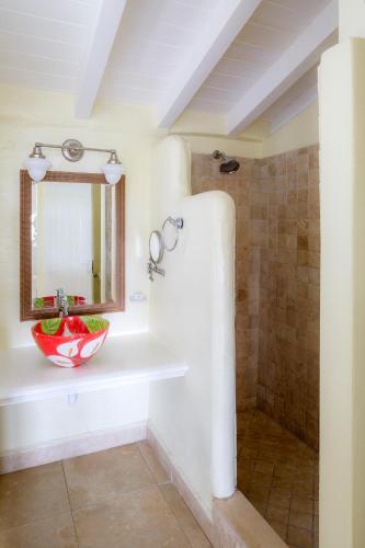a bathroom with a sink and a mirror at Windjammer Landing Resort and Residences in Gros Islet