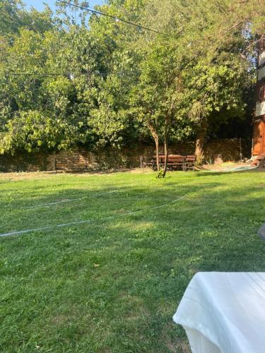 a field of grass with a table and a bench at matilda konak in Safranbolu