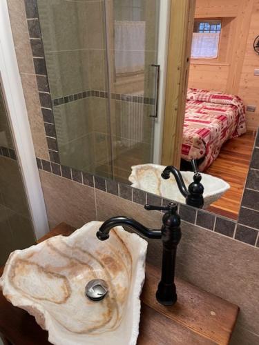 a bathroom with a stone sink and a mirror at La casetta di Piera in Brusson