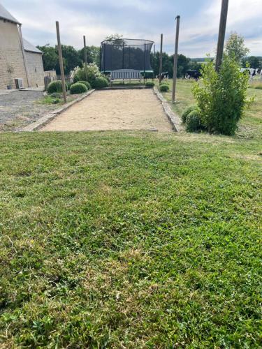 a park with a bench in the middle of a field at Gîte Le Domaine Des Faluns in Le Quiou