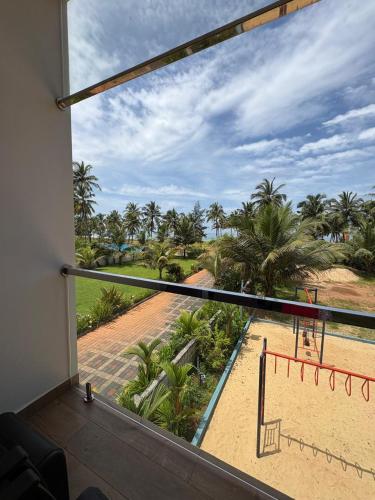 a balcony with a view of a volley ball court at Karkera's Beach Stay in Malpe