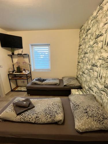 a room with three beds in it with a window at Relax na Lipne in Lipno nad Vltavou
