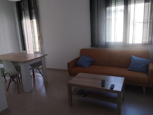 a living room with a couch and a table at Apartamentos calatorao in Calatorao