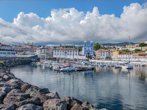 a group of boats are docked in a harbor at Marina Living in Angra do Heroísmo