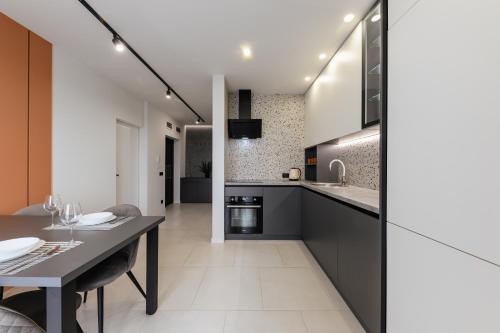 a kitchen with a table and a dining room at Luxury Apartments Babyak in Uzhhorod