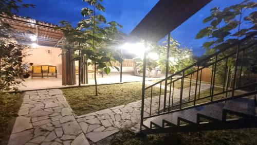 a house with a gate and a stone walkway at New Horizons , villa with 5 bedrooms, whole apartment, апартмент целиком in Dilijan