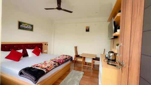 a bedroom with a bed and a desk with a table at Sanchi's Homestay 2BHK in Bhowāli
