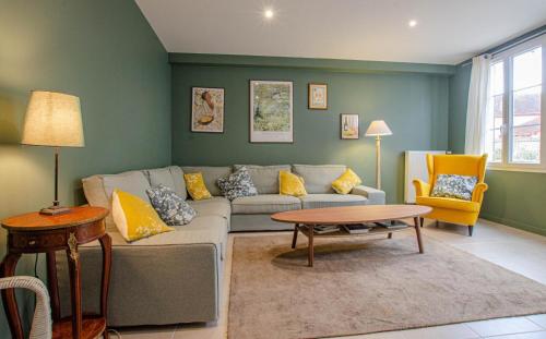 a living room with a couch and a table at Entre seine et vignes in Neuville-sur-Seine