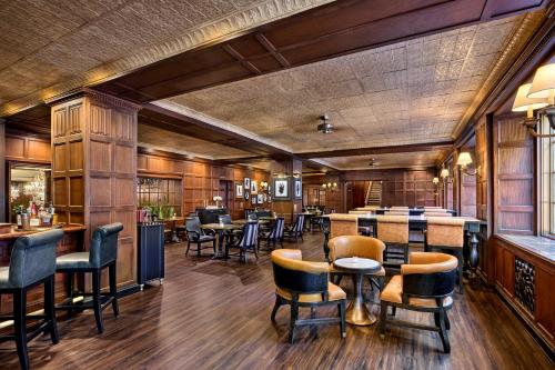 a restaurant with wooden walls and tables and chairs at Boston Omni Parker House Hotel in Boston