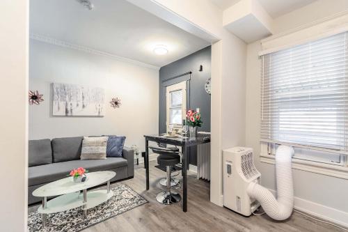a living room with a couch and a desk at Boutique 2BR Apartment on James St North Sleeps 6 in Hamilton