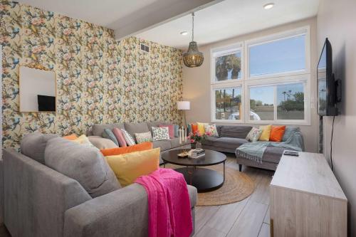 a living room with a couch and a table at Reseda 4BR Pool Villa Hot Tub Arcade & Biliard in Winnetka