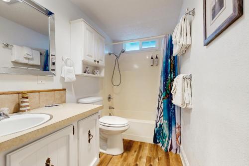 a bathroom with a toilet and a sink at Bella Luna in Lincoln Beach