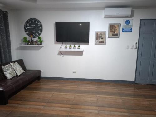 a living room with a couch and a tv on a wall at Villa Armonía in Fortuna