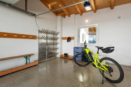 a yellow bike is parked in a garage at Apartmenthaus Stefan in Hippach