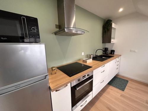 a kitchen with a stainless steel refrigerator and a sink at Superb studio Malo-les-Bains in Dunkerque