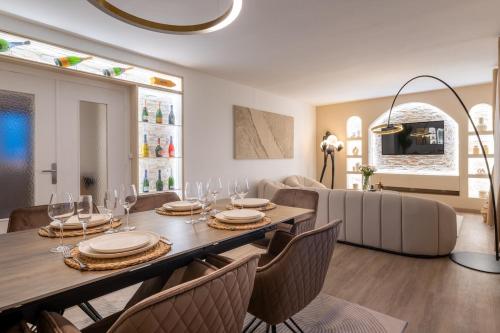 a dining room with a table and chairs at Luxurious 3 Bedrooms Sauna Jacuzzi in Tinqueux