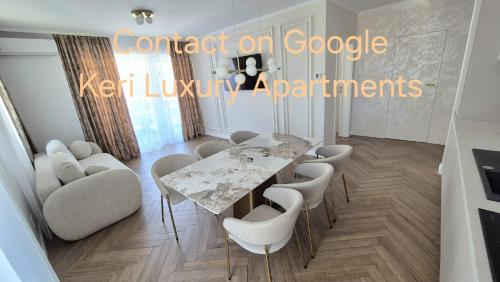 a dining room with a table and chairs at Keri Luxury Apartments in Oradea