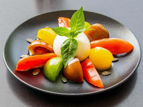 a plate of vegetables with a green leaf on it at Novotel Macon Nord - Porte de Bourgogne in Mâcon