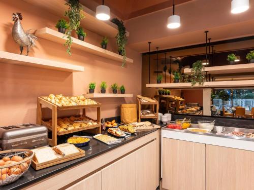 a buffet line with a lot of food at Novotel Macon Nord - Porte de Bourgogne in Mâcon