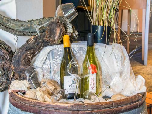 a basket with two bottles of wine and glasses at Novotel Macon Nord - Porte de Bourgogne in Mâcon