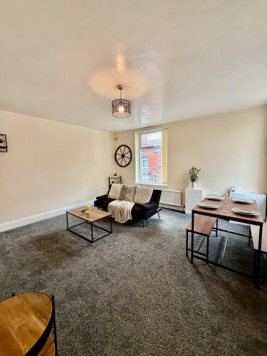 a living room with a couch and a table at Comfy Entire Apartment with Free Parking in Bury Town in Bury