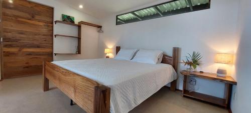 a bedroom with a large bed and a window at Casa Vista Pavones in Pavones