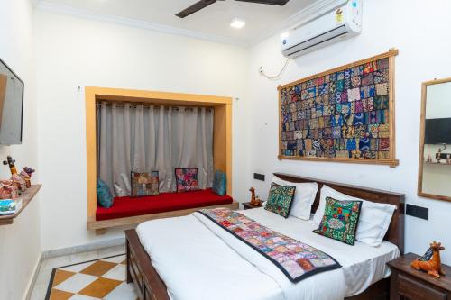 a bedroom with two beds and a window at Sundar Haveli in Jaisalmer