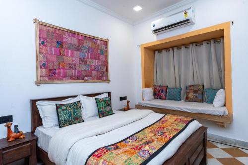 a bedroom with two beds and a window at Sundar Haveli in Jaisalmer