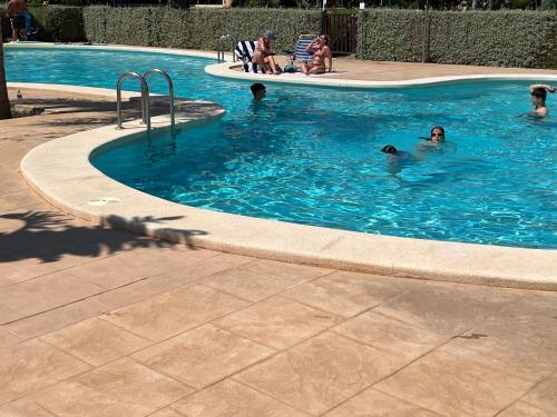 a group of people swimming in a swimming pool at Villa Azul Mar Menor in Torre-Pacheco