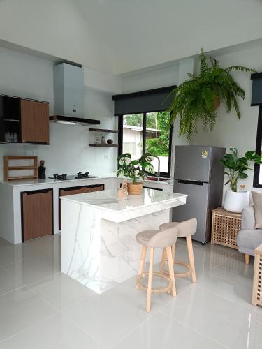 a kitchen with a counter and a stool in it at 5 Minutes to the beach - Stunning 2 Bedroom Pool Villa in Ao Nang 