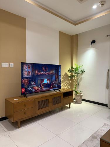 a living room with a large flat screen tv at Elan Spaces 1BHK in Rawalpindi