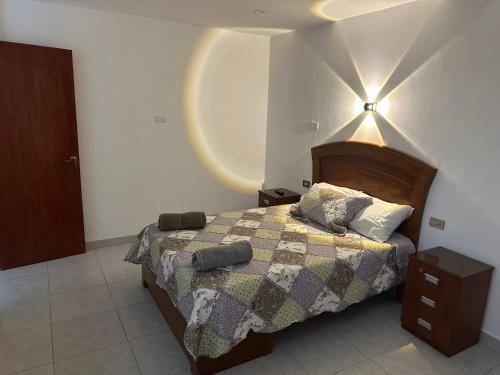 a bedroom with a bed and a light on the ceiling at Casa de Stephano in Lima