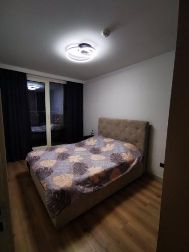 a bedroom with a bed with a quilt on it at Cevahir Sky View in Skopje
