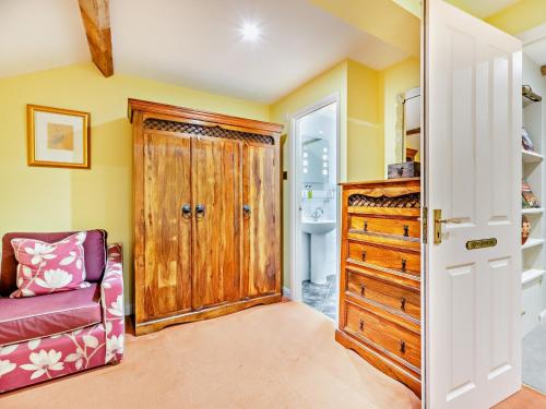 a bathroom with a wooden door and a chair at 1 Bed in Hawes 94120 in Hawes