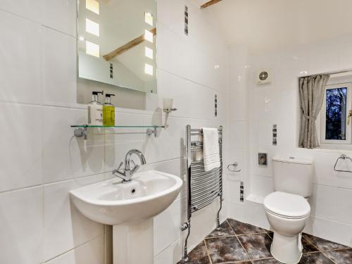 a white bathroom with a sink and a toilet at 1 Bed in Hawes 94120 in Hawes