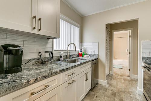 a kitchen with white cabinets and a sink at Walk to Folly Field Beach Condo with Pool Access in Hilton Head Island