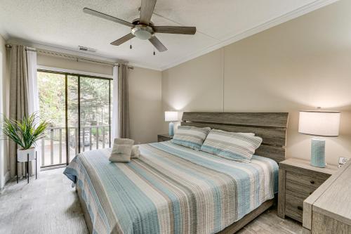 a bedroom with a bed and a ceiling fan at Walk to Folly Field Beach Condo with Pool Access in Hilton Head Island